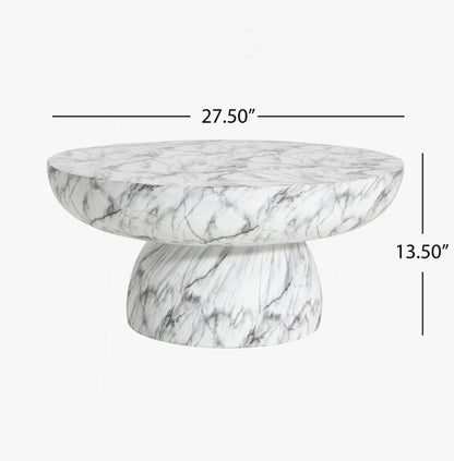 The unique chunky pedestal base of the Patsy Luxe Faux Marble Pedestal Coffee Table adds stability, making it an ideal faux marble table for various settings.