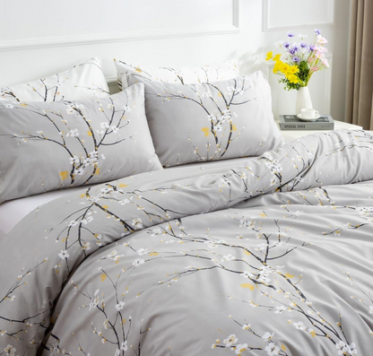 Flat lay of sage green floral duvet set with two pillowcases and soft microfiber texture.