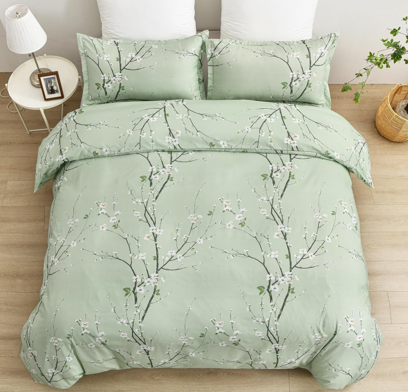 Close-up of sage green floral duvet showing intricate patterns ideal for modern bedroom decor.