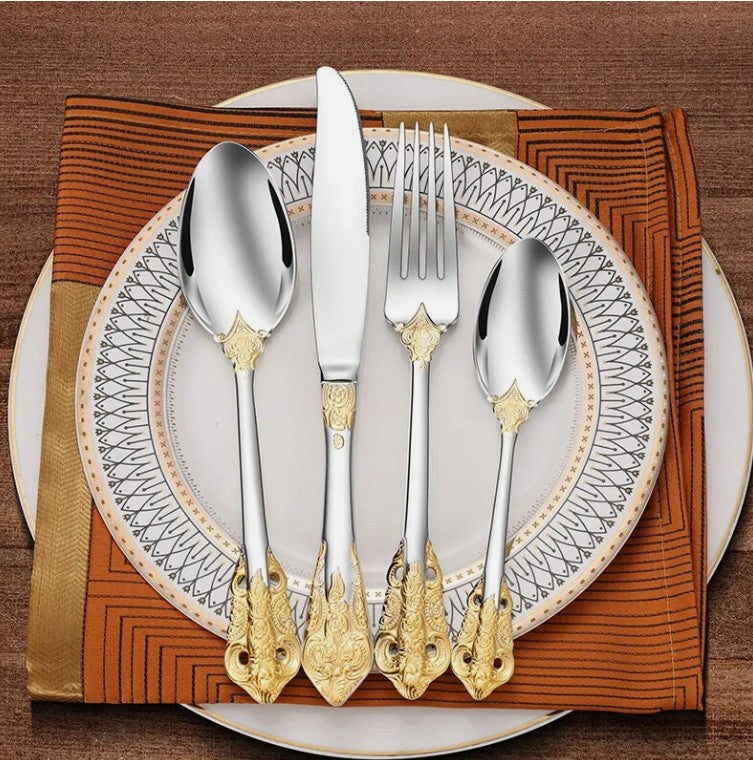 The Everly Quinn Luxury Gold Accent Flatware Set highlighted in a modern dining setting, showcasing its high-end appeal.