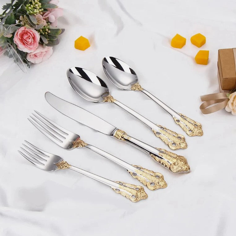 A chic dining scene featuring the Everly Quinn Luxury Gold Accent Flatware Set against elegant tableware, perfect for special occasions.