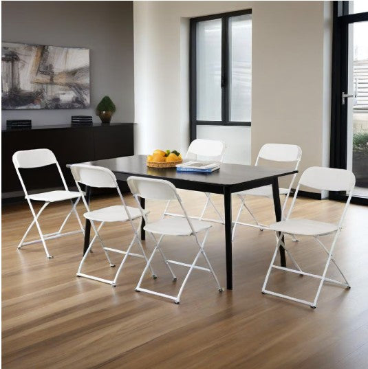 Compact storage of white folding chairs illustrating their practicality and efficiency for event planners.