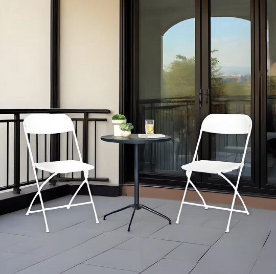 White folding chairs paired with elegant table settings, enhancing the overall decor for events.