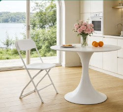 A single white folding chair in an outdoor setting, perfect for weddings, events, and gatherings.
